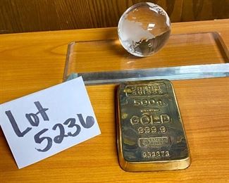 Lot 5236.$32.00.  Credit Suisse 500g Gold 999.9 Replica (5"l x 3"w) Paired with a crystal globe on base (10"l x 4"w x 3"dia)