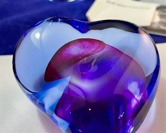 Lot 5128. $300.00. Kosta Boda Swedish Studio Art Glass pair, the first item is a Kosta Boda  by Gorän Warff Crystal Vase with contemporary beautiful lines and striking colors (11"t x 4"w) #49809, and a Kosta Boda heart beat art glass paperweight (3"x3"x1") by Bertil Vallien #90117 (both with boxes)