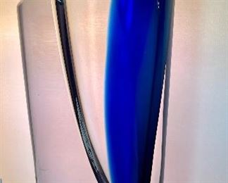 Lot 5128. $300.00. Kosta Boda Swedish Studio Art Glass pair, the first item is a Kosta Boda  by Gorän Warff Crystal Vase with contemporary beautiful lines and striking colors (11"t x 4"w) #49809, and a Kosta Boda heart beat art glass paperweight (3"x3"x1") by Bertil Vallien #90117 (both with boxes)