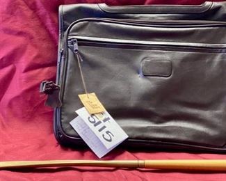 Lot 5115.  $85.00. Brown Leather "The Shoe Horn" Saddle Bag. Used to go over a Suitcase for additional storage. 2 zipper pockets and 1 zipper compartment. 16" W  x 12" H.  In addition we have included a  solid brass shoe horn. 16" W  x 12" H