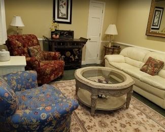 Staged room - red chair, coffee table, off-white leather couch, area rug ...all available!