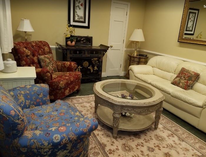Staged room - red chair, coffee table, off-white leather couch, area rug ...all available!