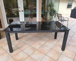 Black shadowed gloss finish thick glass table versatile to be used inside or outside.  *we also have an w/extra leaf