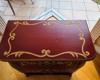 Top view of black and red three drawer chest or side table
