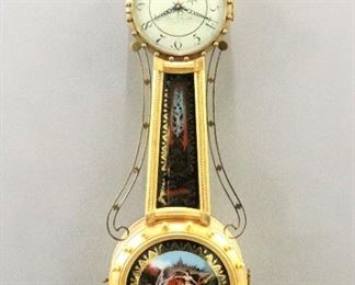 A late 20th century Elmer O. Stennes Girandole wall clock.  8-day weight driven time only movement marked "E. O. Stennes, Weymouth, Mass. 4" with convex metal dial and Arabic numerals also marked with a "Bee" at 6:00.  Shaped case with White body and gilded front having a carved Eagle finial above circular upper door with convex glass over a curved throat glass with reverse painted decoration and "Patent" with Brass side arms over a circular lower door with convex glass and reverse painted "Aurora" decoration and a foliate carved drop. The weight is marked "E. O. Stennes" in the casting, the case is stamped with the numerals "16" in several locations.  Minor case and finish wear, running when cataloged.  44" high overall.  ESTIMATE $2,000-4,000

