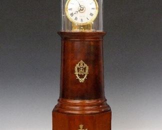 A late 20th century Lighthouse clock by David Lindow, Lake Ariel, PA after the original by Simon Willard.   8-day weight driven time and strike movement with alarm, porcelain dial with Roman numerals and subsidiary alarm indicator dial at center, marked "Simon Willard".  Stamped "H L F" monogram on rear plate for "Hartwigs, Lindow, Fucci"  clock #7.  Mahogany case by William G. Towne with blown glass dome and applied Brass decoration.  Very good condition with only slight wear, running when cataloged.  30 3/4" high overall.  ESTIMATE $4,000-6,000  This lot includes a letter from Lindow to Mr. Ruscilli discussing this clock at the time of purchase.
