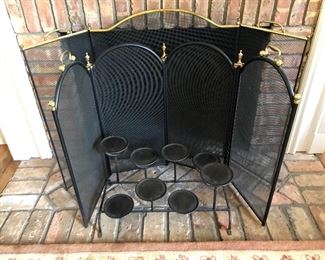 TWO fireplace screens and a candle holder.