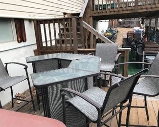 This is an outdoor bar/eating area. High top Chairs and bar