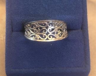 marked 925  band ring  approx size 9.5  tapered  in the back  has a designer mark  but i  don't know the brand  $18