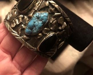 large cuff  maybe nickel silver - does not test 925 -but looks it  stones are good i believe  onyx  and turquoise maybe  great statement piece for $35