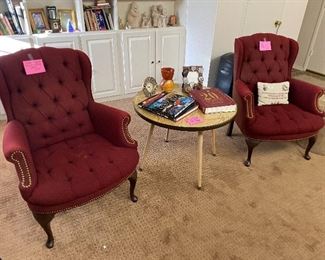 Pair of red wing chairs with nail head trim