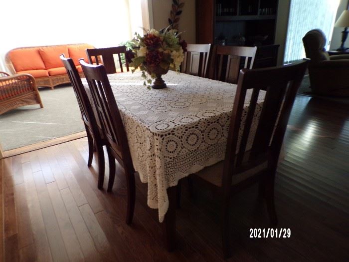 dining table w/tile top & 6 chairs, sun furniture in background