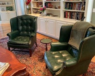 Pair of green leather wing backs, matching foot stools discovered in garage