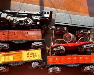 Vintage Lionel tin cars including Baby Ruth boxcar and spot light
