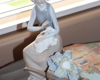 Girl with lamp and flowers in wheelbarrow