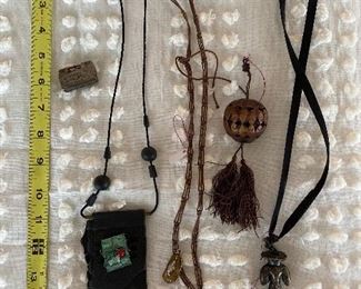 Left: Silver box $15; Long next with pouch $12; Long necklace with silver box $15; Tassel $4; Long necklace with figurine $12
