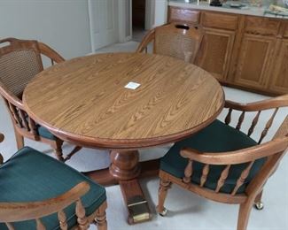 dinette  set with  four  chairs  on  wheels.  It  is  44" in diameter.  Price  is  295.00