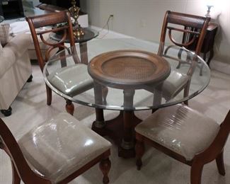 Round  glass top dinette  set  with  four  chairs   52"     250.00