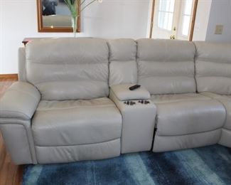 Leather theater set with two electric recliners and one manual recliner. Corner piece and console piece with cup holders.  Electronics connections too.