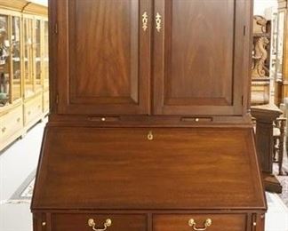 1020	HENKEL HARRIS WALNUT SECRETARY DESK, 2 PART SOLID WALNUT W/BLIND DOORS & CARVED ARCH PEDIMENT TOP, PULL OUT CANDLE HOLDERS & REEDED QUARTER COLUMNS, 94 IN HIGH X 40 IN WIDE X 22 IN DEEP
