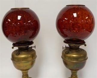 1053	PAIR OF ANTIQUE BRASS KEROSENE LAMPS W/RUBY GLASS HONEYCOMB GLOBES, BURNERS MARKED DUPLEX ENGLAND, 23 IN HIGH
