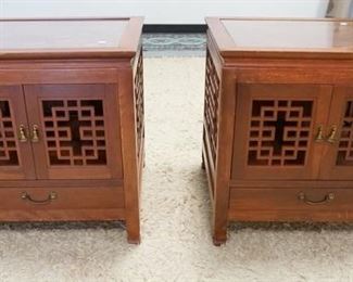 1149	PAIR OF SQUARE CARVED LAMP STANDS THE HAVE GLASS TOPS TWO DOORS & ONE DRAWER & FRET WORK SIDES. THEY HAVE SCENIC CARVING ON THE TOPS. 24 IN SQ 24 IN H 
