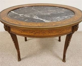 1160	INLAID BRASS MOUNTED OVAL TABLE W/ INSET BLACK MARBLE TOP. 30 1/2 IN X 23 1/4 IN 20 IN H 
