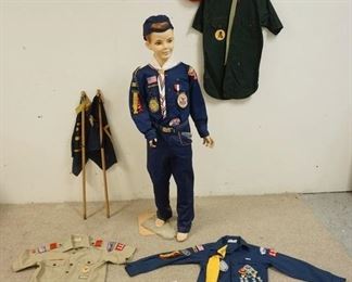 1226	MANNEQUIN CLOTHED IN CUB SCOUTS UNIFORM W/ PATCHES,  A BELT W/ CUB SCOUTS BELT BUCKLE A CUB SCOUTS CAP. PLUS THREE BOY SCOUTS UNIFORM SHIRTS W/ PATCHES A BOY SCOUT BERET & A PHILMONT 1976 SCARF. MANNEQUIN IS MISSING FINGERS ON RIGHT HAND & MAY SUFFER LOSSES TO BODY/FACE IT IS APP. 56 IN TALL

