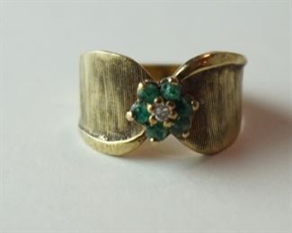 1277	MARKED 14K GOLD RING WITH 6 EMERALDS AND DIAMOND FLOWER, STONES UNTESTED. APPROXIMATE WEIGHT WITH STONES 3.178
