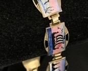 Askel Holmsen Sterling Silver Guilloche Enamel Norwegian Scenic Bracelet. Classic Norwegian enamel bracelet showing 9 different Nordic outdoor scenes. Excellent condition, all enamel smooth and intact. Clasp works well. Marked "925S", Askel Holmsen stamp. Dimensions: 7.5" l x 1/2" wide. Wt. 17.8 gm. 