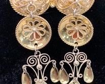 An unusual piece of classic Norwegian solje jewelry, this brooch has two round domes which each host three layers of dangling disks and spoons. All pieces intact and in pristine condition. The brooch has a C clasp and a tube hinge, and is hallmarked "830S AD". Dimensions: 1-5/8" w x 2.5" l x 3/8" d. Wt. 10.9 gm.