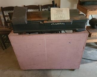 Top is Craftsman Jointer6' inch model # 103.20620 With instruction book sitting a top. bottom custom table as they did not come with one. Holds motor, plugs, etc