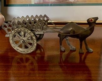 brass camel pulling cart with red rhinestone eyes
