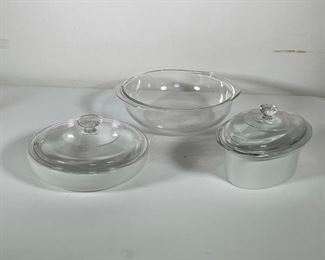 Lot 132 | (3pc) OVENWARE DISHES | Including a handled Pyrex bowl (h. 3 x w. 11-3/4 in.), a covered Corning round bowl, and a Arabia dutch oven with clear glass cover (made in Finland) 