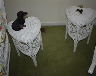 Two Beautiful White Wicker Heart Shaped  Tables guarded by a pair of appealing Dachshunds