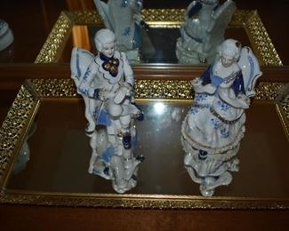 Colonial Figurines sitting atop a Gold Framed Dresser Mirror