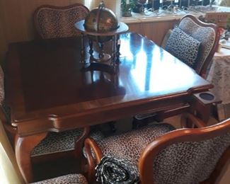 Game Table that comes with a leaf that converts the table into a dining table. There are 4 chairs on casters and a bench. Pull out coaster drawers on each corner!