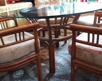 Vintage bamboo dinette set with glass top. Custom upholstered cushions. 48" diameter