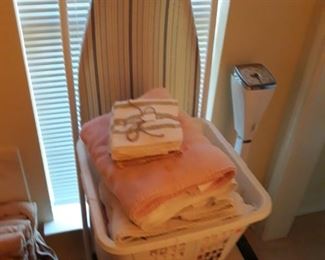 Ironing board, vanity stool, and towels.