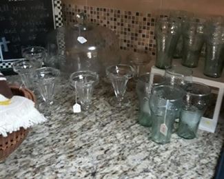 Glass dome cake stand, soda glasses, and Coca Cola glassware.