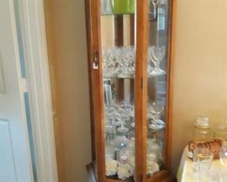 Lighted display cabinet and glassware.