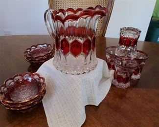 Cranberry glass, pitcher has crack, matching glasses and bowls