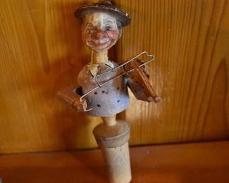 DSC 1517 Vintage ANRI style Mechanical Wooden  Bottle Stopper each Stopper operates similar to a nutcracker, this one plays the violin. These are very difficult to find