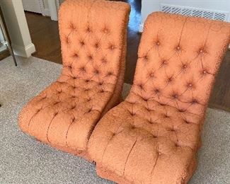 Two MCM vintage low lounge chairs in an orange tufted fabric