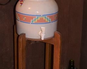 Water dispenser; pottery on wood stand