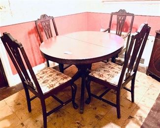Vintage table and four chairs 
table has brass feet and some veneer chipping 
chairs have ball and claw feet   set $400