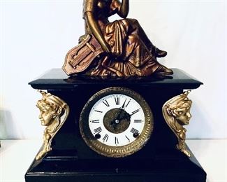 Iron case with statue Clock 
not running but has a key 
15.5 wide 19 tall $200