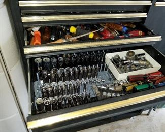 upright tool cabinet, loaded with tools
