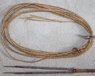 Vintage 40’ Rawhide Lariat. Also shown is a Carved Wooden Handmade/Decorated what appears to be some sort of Tribal Weapon.