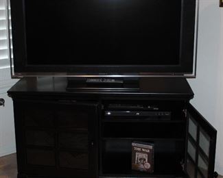 Sony Bravia 46” LCD HDTV Model #KDL46XBRA on a Black Glass Pane Double Door TV Stand